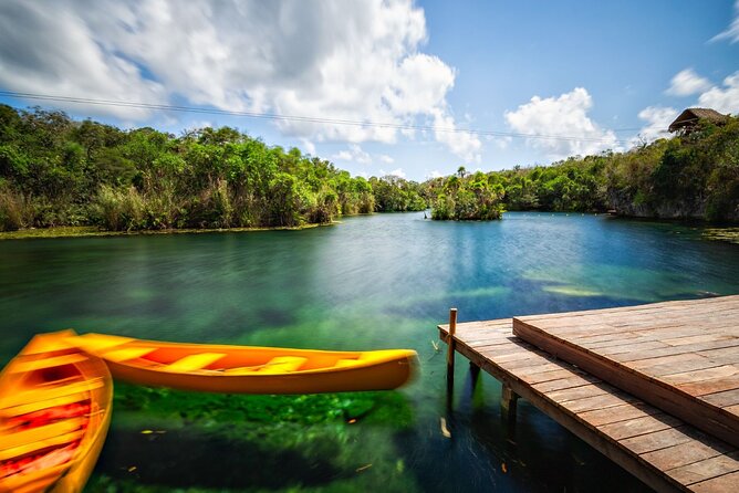 Cenote Tankah and Mayan Village Tour with Zipline, Canoes & Lunch - Swimming through the Tankah cenotes