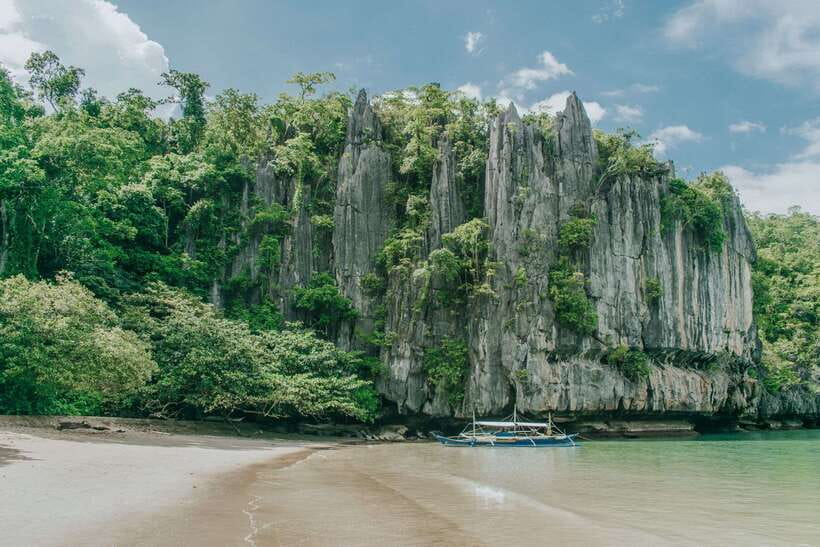 Puerto Princesa: Underground River, Zipline, Paddleboat Tour - Sabang wharf and the boat to the cave